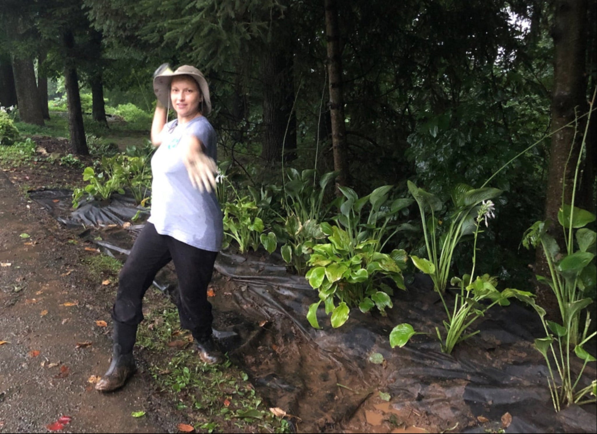 Molly standing with freshly planted hostas